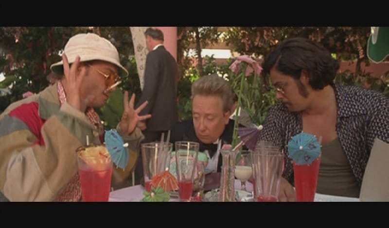 Still from Fear and Loathing in Las Vegas — three characters gathered around a table of drinks