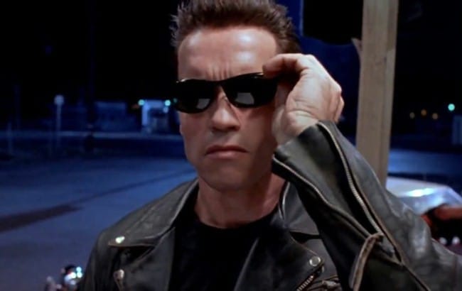 Still from Terminator 2: the T-800 lowers his sunglasses on a street at night